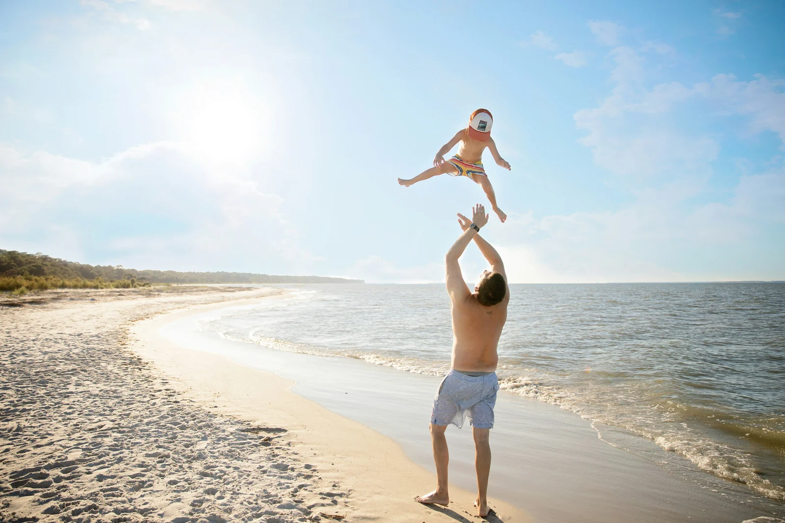 Family playing on a sunny Gulf Coast beach