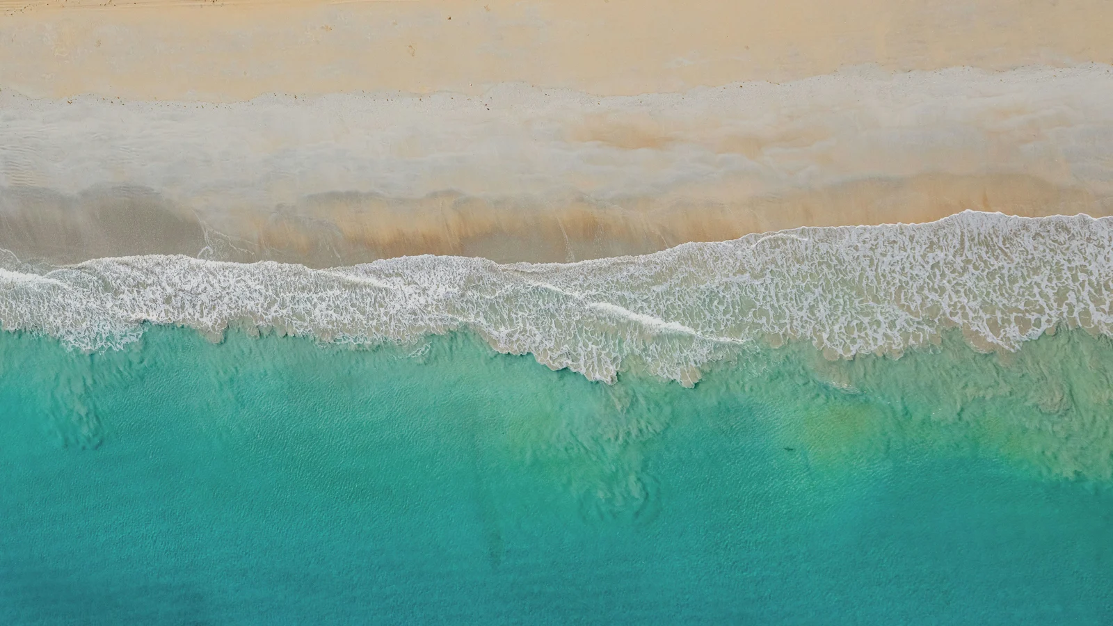 Sugar-white sand and emerald Gulf water at Pensacola Beach