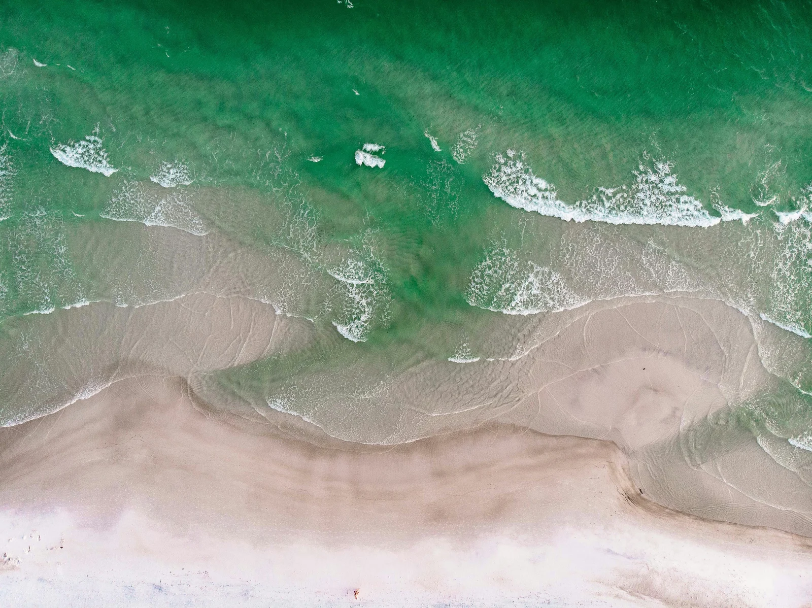 Kayakers paddling emerald coastal waters near Pensacola Beach