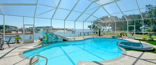 Lucky View luxury waterfront vacation rental, screened pool with private dock and waterway views, Pensacola Beach Florida